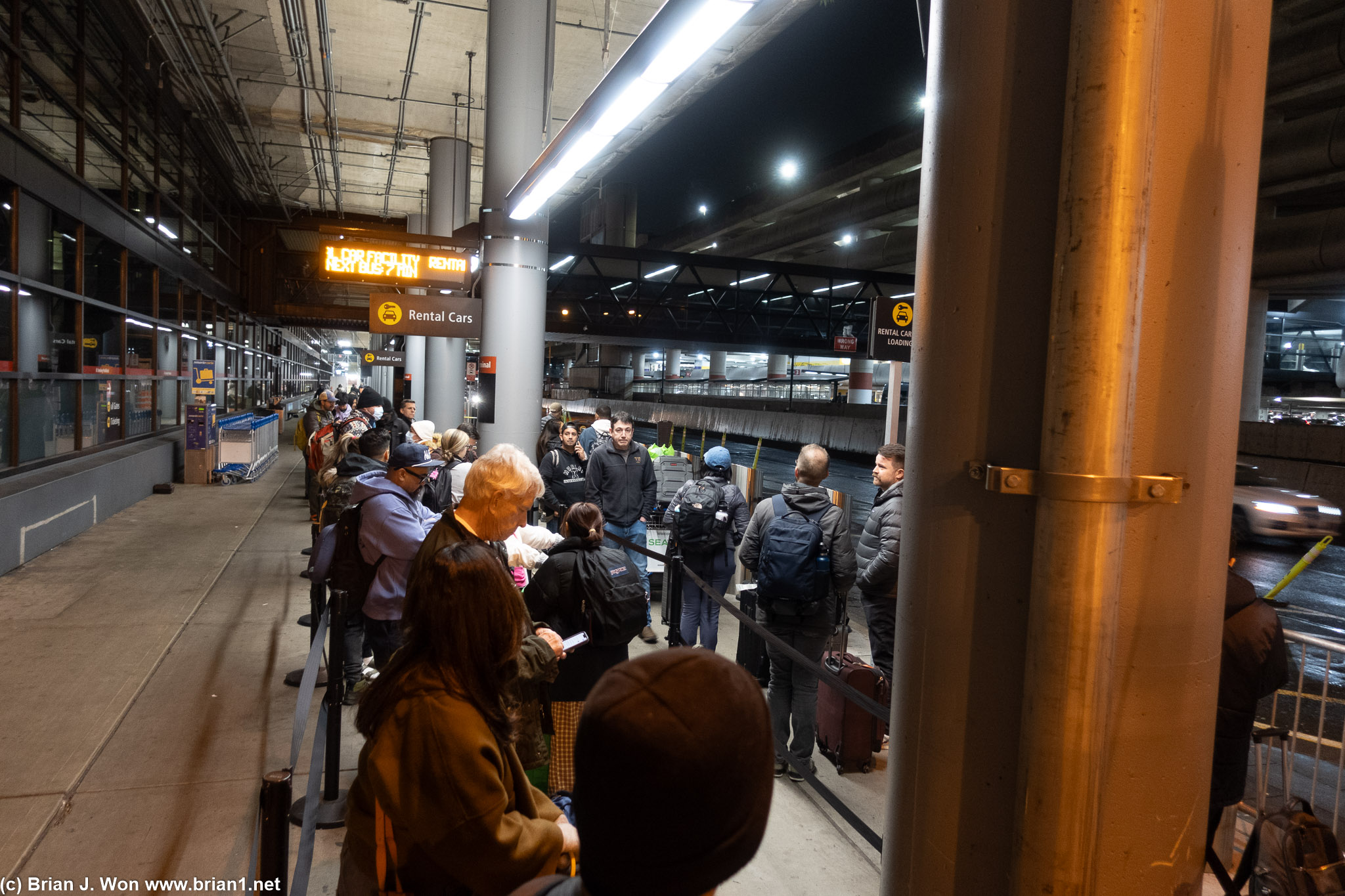 Long line for rental car shuttle.