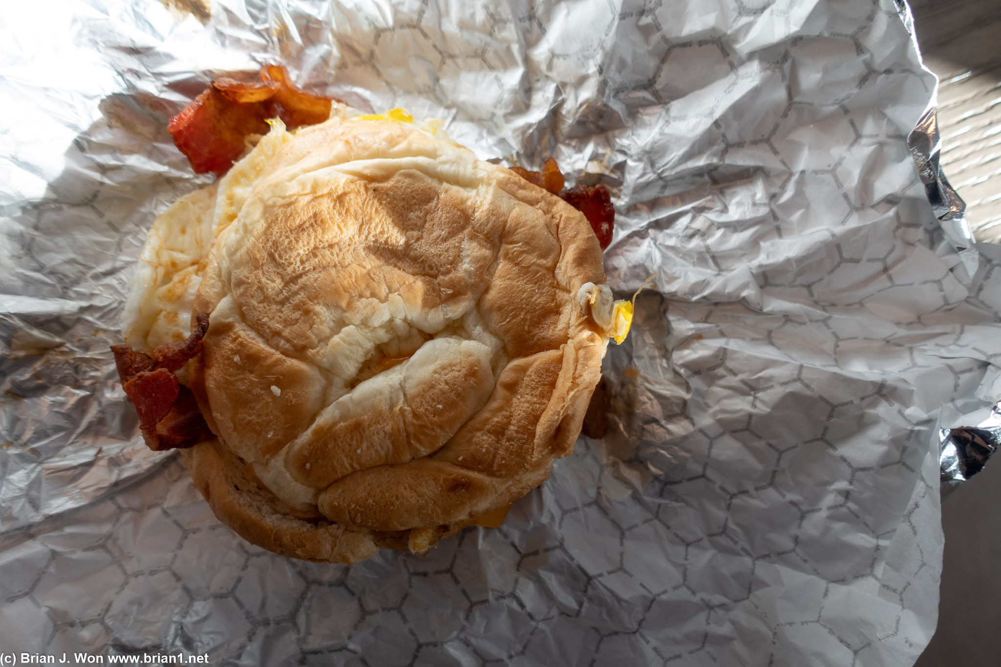 Bacon, egg, cheese, and croissant breakfast sandwich.