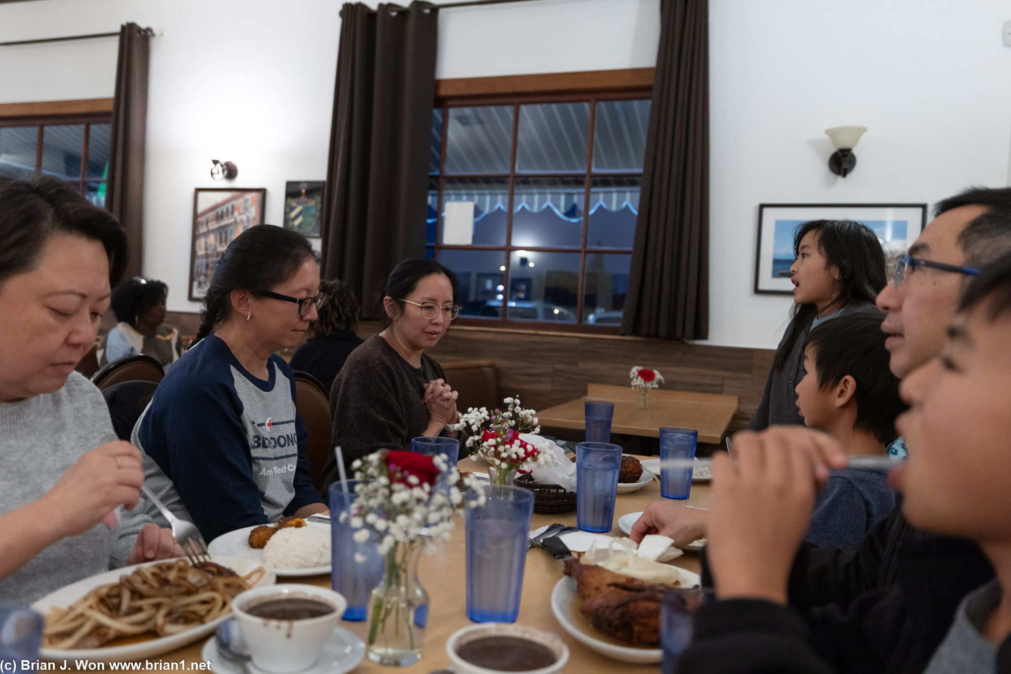 The Udom kids watching TV while eating dinner.