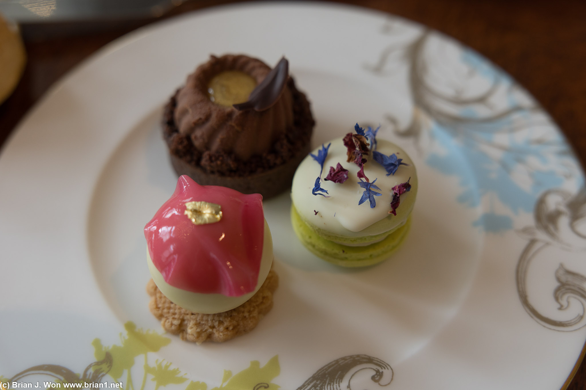 Earl grey and Lapsang tea chocolate tart, verbena and rose gel macaron, lychee and apple sphere.