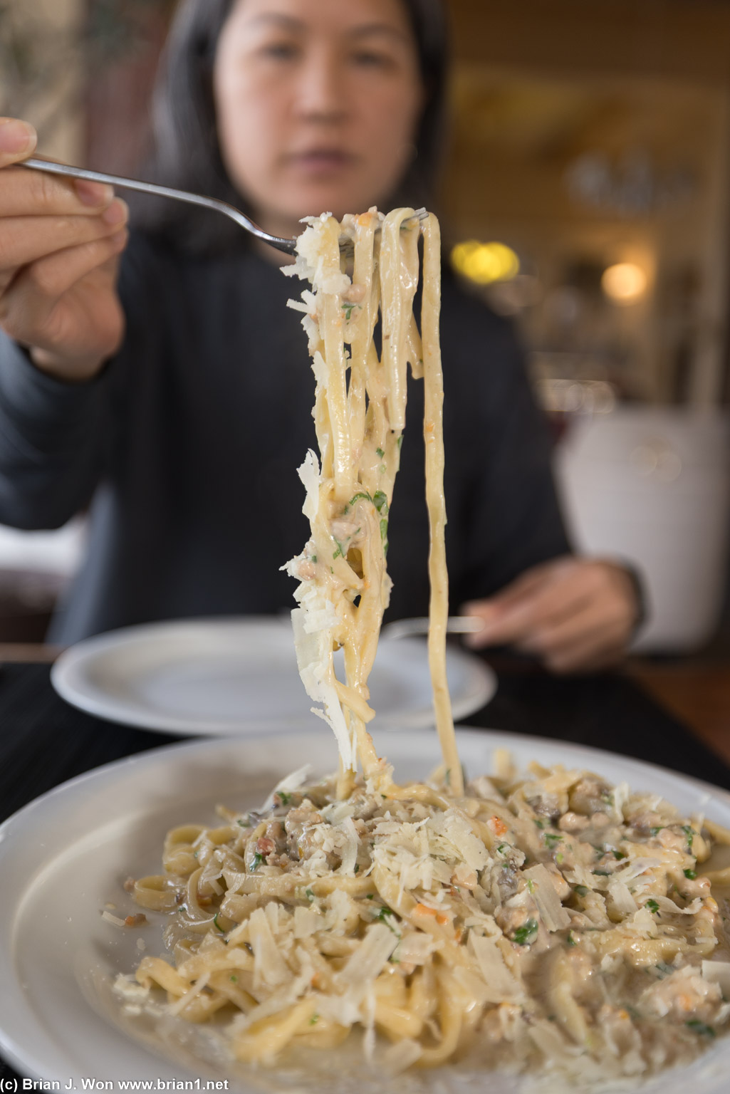 Dishing out seafood pasta.