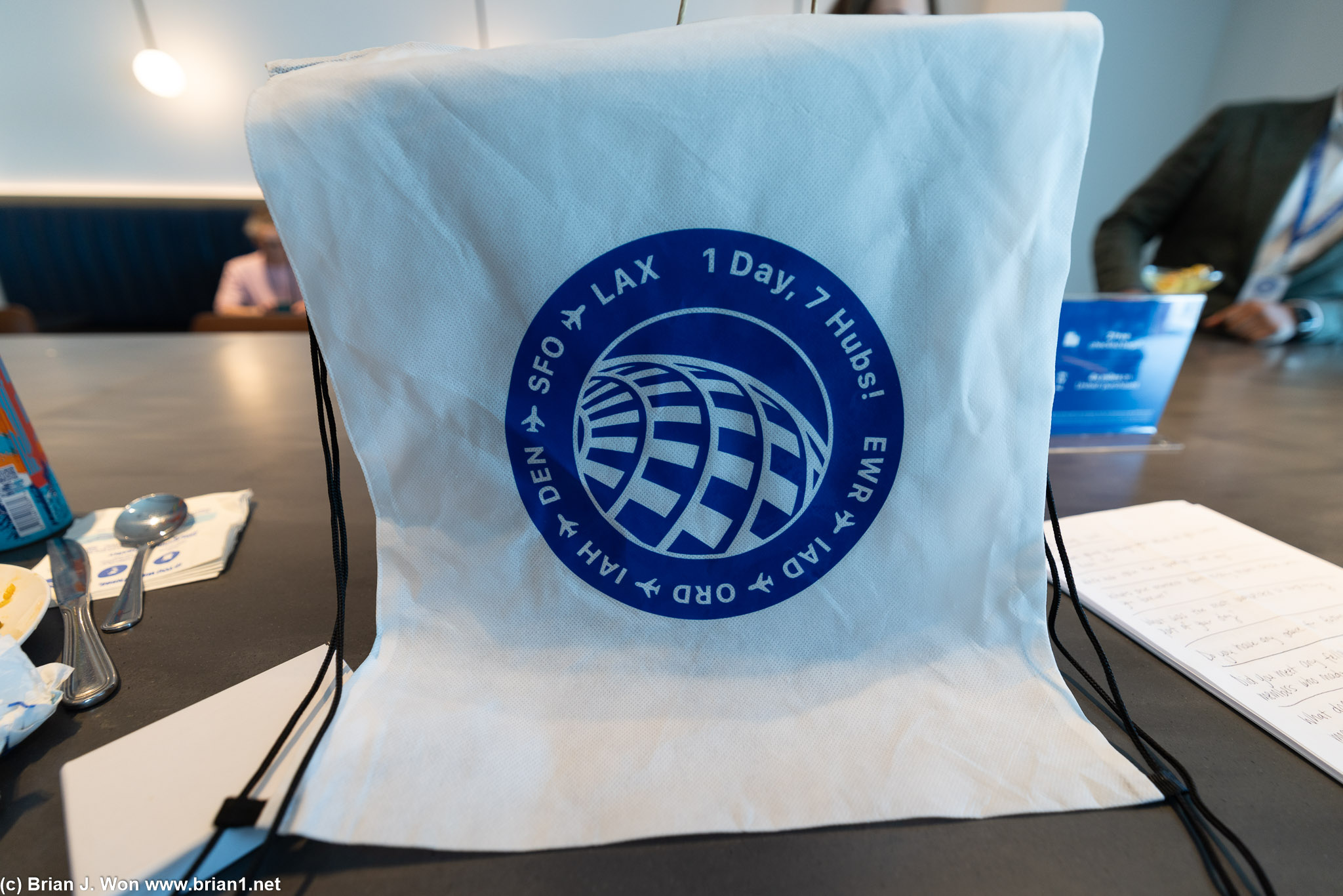 Warren distributes gift #4 to the group, drawstring backpacks.