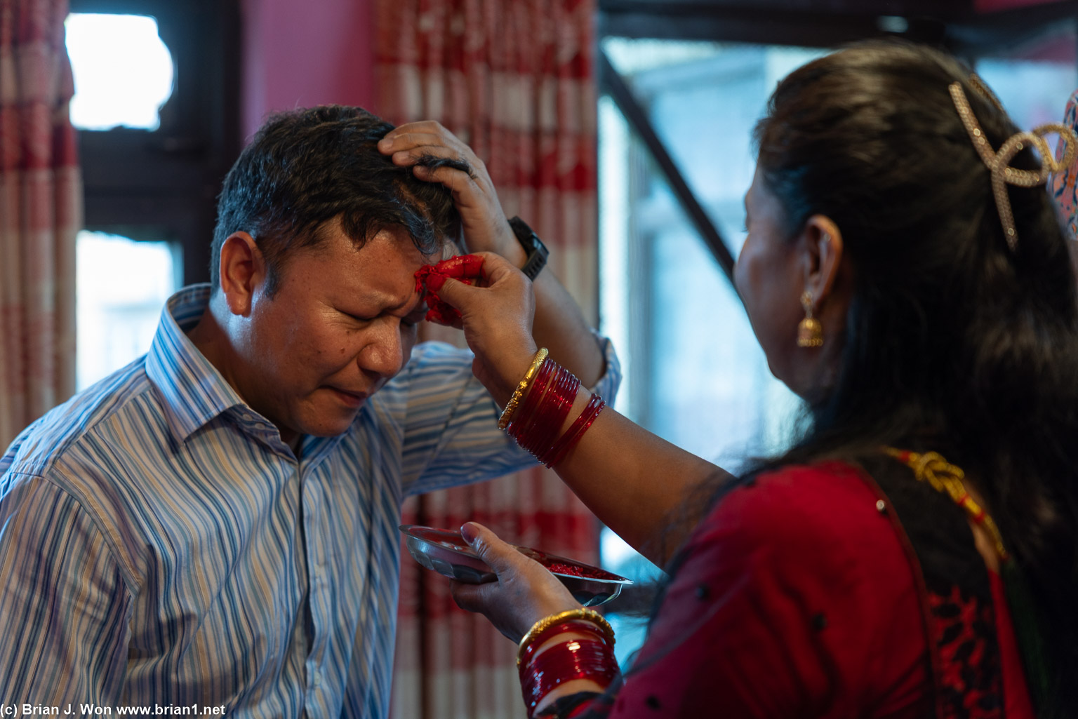 Tika (placing of rice on forehead for blessings).