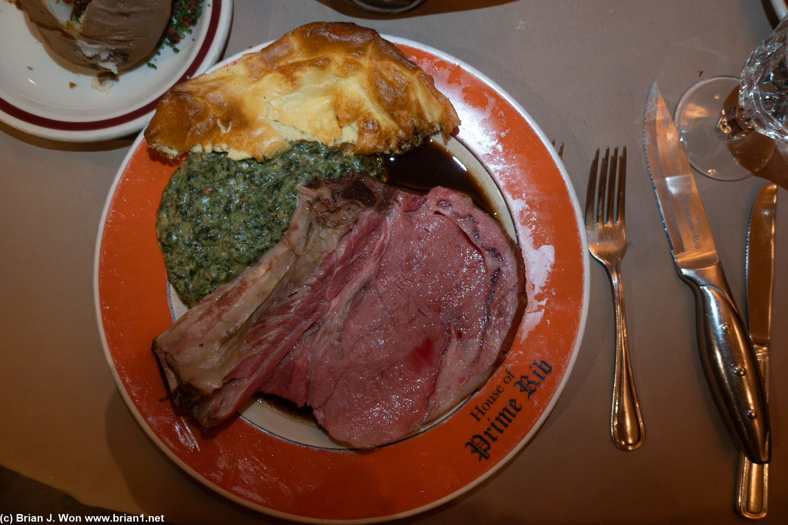 King Henry VIII cut with creamed spinach, yorkshire pudding, and loaded baked potato.