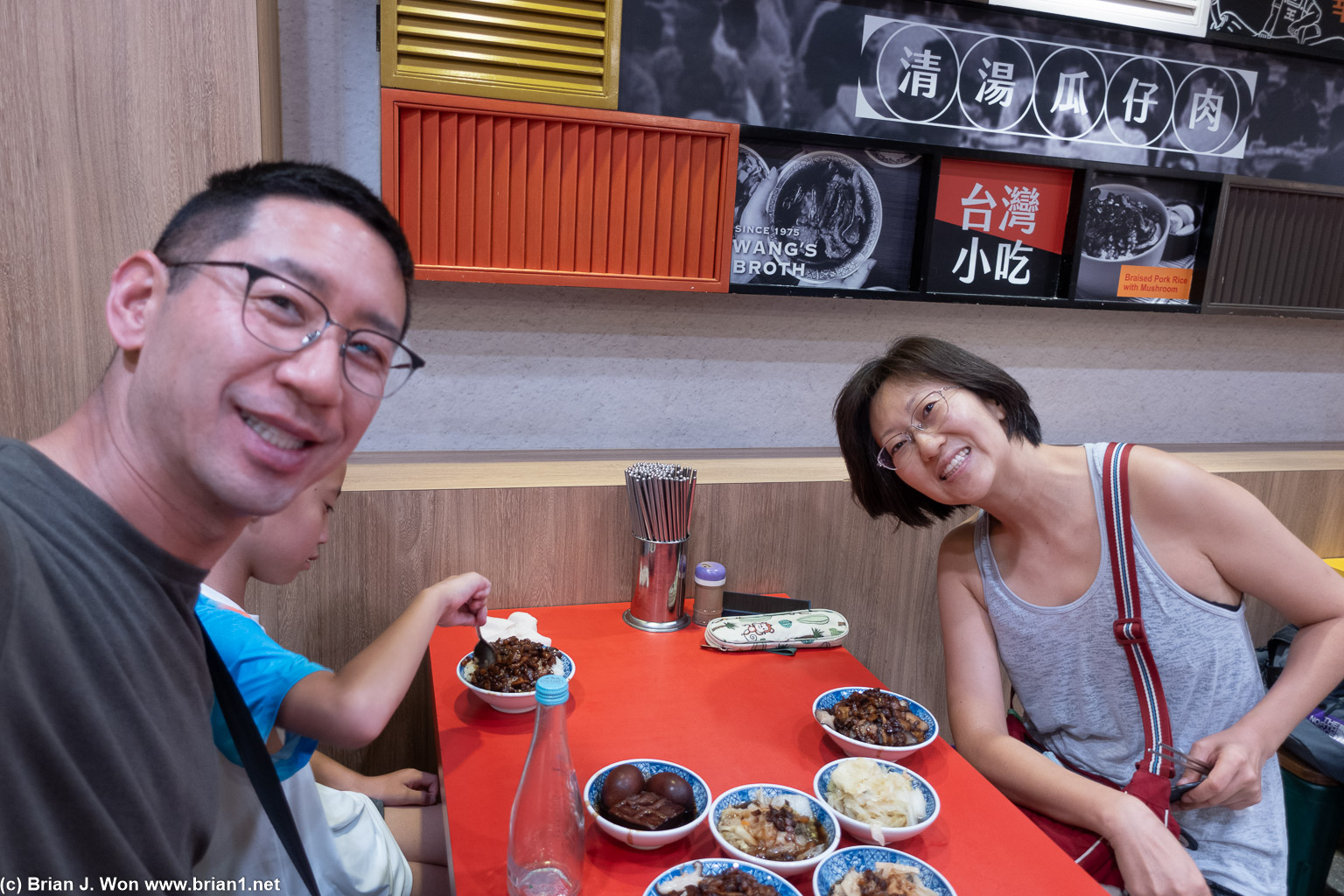 Adults being goofy, child picking at his food.