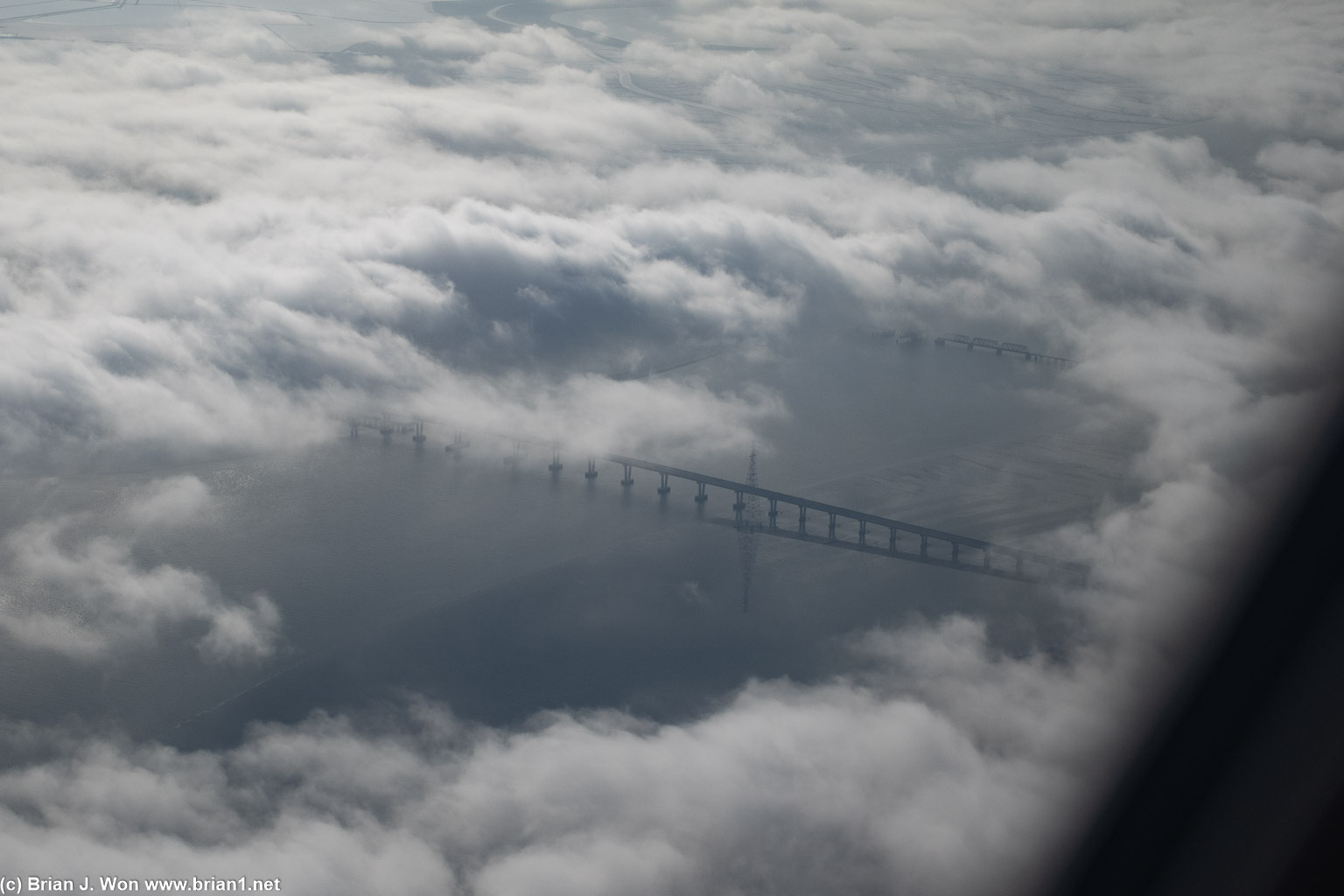 The Dumbarton Bridge and its accompanying rail bridge peeking through the fog.