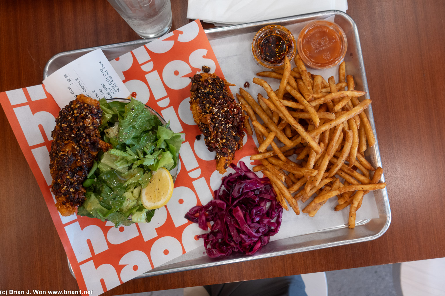 Salad, coleslaw, mound of fries, fried chicken.