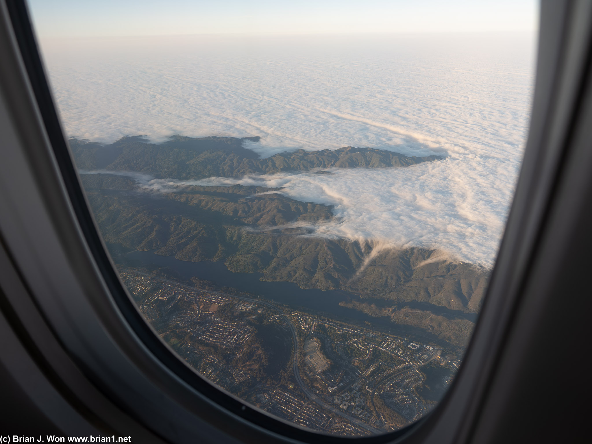 Fog overwhelms the coast to the west of San Andreas Lake.