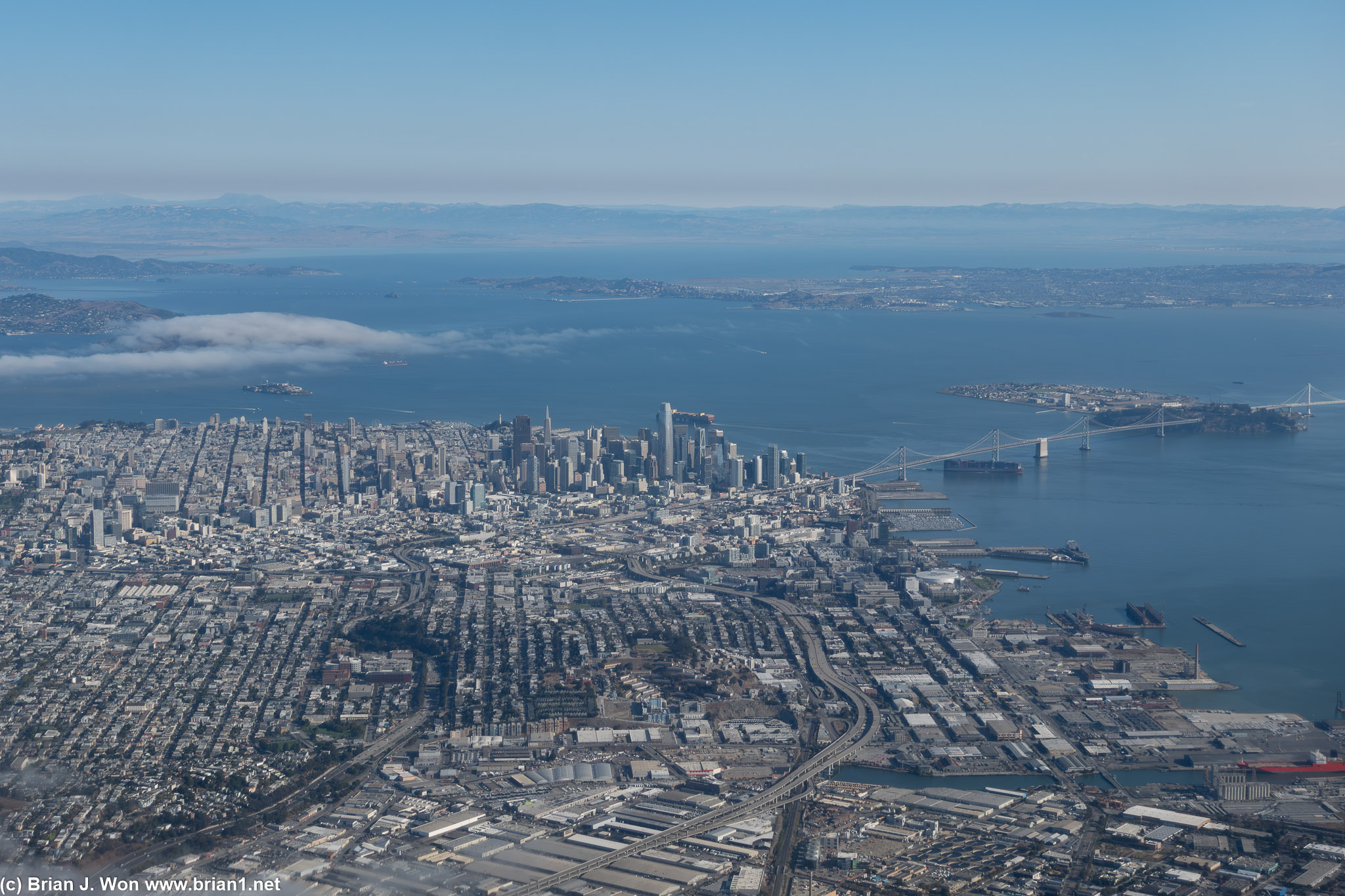 San Francisco skyline and the Bay Bridge visible as United flight 1851 takes off from San Francisco International Airport.