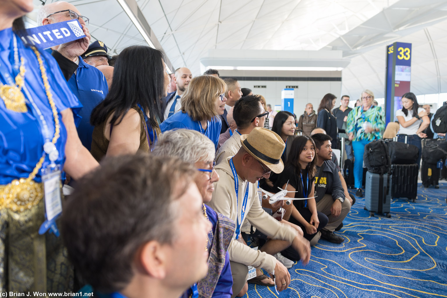 Inaugural flight passengers posing for a big group photo.