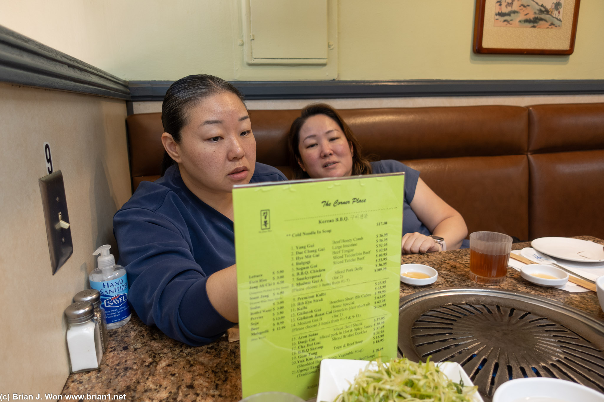 Christina and Kristina agnozing over the menu.